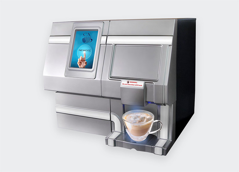 An office coffee machine making coffee and being poured into a mug